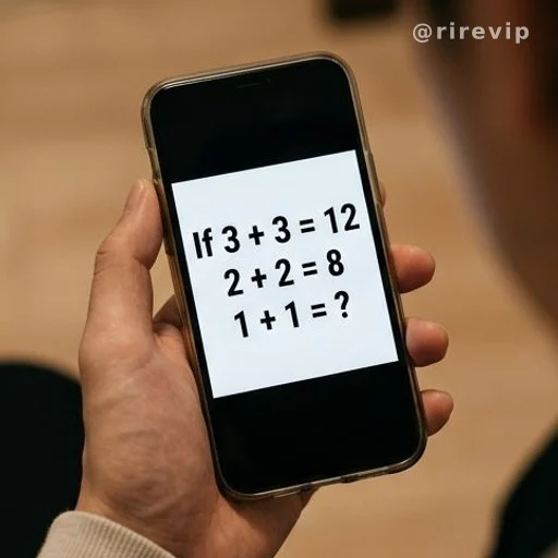 Smartphone showing a viral math riddle with two age equations
