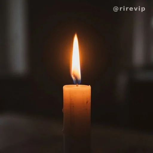 Single candle flame burning in darkness, symbolizing fire that can die
