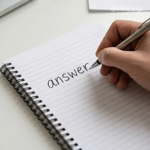 Hand writing the answer to a riddle on a notepad